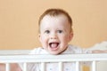 Happy baby age of 9 months in white bed Royalty Free Stock Photo