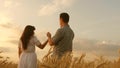 Happy baby in arms of father and mother. little daughter, dad and mom play in wheat field. baby travels across field Royalty Free Stock Photo