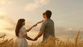 Happy baby in arms of father and mother. little daughter, dad and mom play in wheat field. baby travels across field Royalty Free Stock Photo