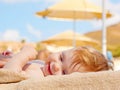 Happy baby on the beach sunbed.