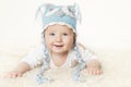 Happy Baby in Blue Knitted Hat, Smiling Kid Boy Raising Head Royalty Free Stock Photo