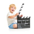 Happy baby boy with clapper board sitting on floor Royalty Free Stock Photo