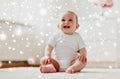 Happy baby boy or girl sitting on floor at home Royalty Free Stock Photo