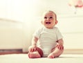 Happy baby boy or girl sitting on floor at home Royalty Free Stock Photo