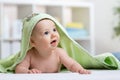 Happy baby in green towel after bathing Royalty Free Stock Photo