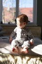 Happy baby boy in grey pyjamas Royalty Free Stock Photo