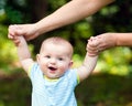 Happy baby boy learning to walk on grass Royalty Free Stock Photo