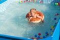 Happy baby boy playing with colorful inflatable ring Royalty Free Stock Photo