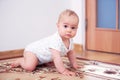 Happy baby boy playing on floor in children& x27;s room Royalty Free Stock Photo