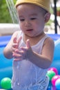 Happy Baby Boy Playing water and toy ball in the Swimming Pool Royalty Free Stock Photo