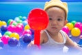 Happy Baby Boy Playing water and toy ball in the Swimming Pool Royalty Free Stock Photo