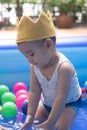 Happy Baby Boy Playing water and toy ball in the Swimming Pool Royalty Free Stock Photo