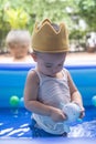 Happy Baby Boy  Playing water and toy ball in the Swimming Pool Royalty Free Stock Photo