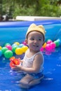 Happy Baby Boy Playing water and toy ball in the Swimming Pool Royalty Free Stock Photo