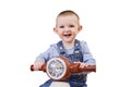 Happy baby boy rides a plastic children motorcycle in the playroom, iso