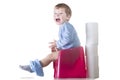 Happy baby boy sitting on chamber pot Royalty Free Stock Photo