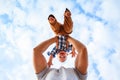 A happy baby boy is spinning against the sky background. Dad plays with the child, throwing it in the air Royalty Free Stock Photo