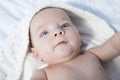 Happy baby boy wrapped bath towel after bath in bed at home Royalty Free Stock Photo