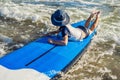 Happy baby boy - young surfer ride on surfboard with fun on sea waves. Active family lifestyle, kids outdoor water sport Royalty Free Stock Photo