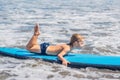 Happy baby boy - young surfer ride on surfboard with fun on sea waves. Active family lifestyle, kids outdoor water sport Royalty Free Stock Photo