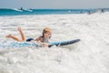 Happy baby boy - young surfer ride on surfboard with fun on sea waves. Active family lifestyle, kids outdoor water sport Royalty Free Stock Photo