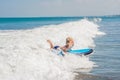 Happy baby boy - young surfer ride on surfboard with fun on sea waves. Active family lifestyle, kids outdoor water sport Royalty Free Stock Photo