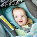 Happy baby buckled into car seat