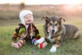 Happy Baby Bundled up Outside in Winter with Pet Dog