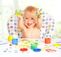 Happy baby child draws with colored paints Royalty Free Stock Photo