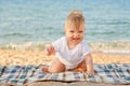 Happy baby crawling on the beach. Royalty Free Stock Photo