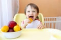 Happy baby eating fruits Royalty Free Stock Photo