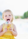 Happy baby eating two ice cream horns Royalty Free Stock Photo