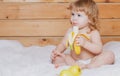 Happy baby eats banana. Fresh vegetables and fruits. Child eating, nutrition concept. Royalty Free Stock Photo