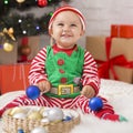 Happy Baby Elf With Christmas Decorations Laughing
