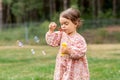 happy baby girl blowing soap bubbles in summer Royalty Free Stock Photo