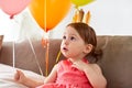 Happy baby girl in crown on birthday party at home Royalty Free Stock Photo