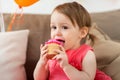 Happy baby girl eating cupcake on birthday party Royalty Free Stock Photo