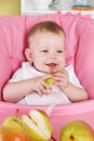 Happy baby girl eating fruit Royalty Free Stock Photo