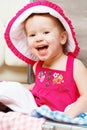 Happy baby girl is going on trip, pack suitcase Royalty Free Stock Photo