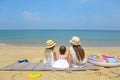 Happy baby girl and her sisters playing in sand on a beautiful beach Royalty Free Stock Photo