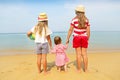 Happy baby girl and her sisters playing in sand on a beautiful beach Royalty Free Stock Photo