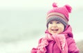 Happy baby girl in a pink hat and scarf Royalty Free Stock Photo