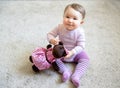 Happy baby girl plays with toy bear Royalty Free Stock Photo