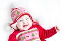 Happy baby girl in red dress with Christmas ornament Royalty Free Stock Photo