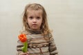 Happy baby girl rejoices and smiles with a bouquet of multi-colored tulips in hands Royalty Free Stock Photo