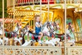 Happy baby girl rides a carousel on a horse in an amusement Park in summer Royalty Free Stock Photo