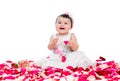 Happy baby girl among rose petals Royalty Free Stock Photo