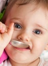 Happy baby girl with spoon Royalty Free Stock Photo