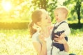 Happy baby girl in a wreath on meadow with yellow flowers on t Royalty Free Stock Photo