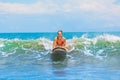 Young surfer rides on surfboard with fun on sea waves Royalty Free Stock Photo